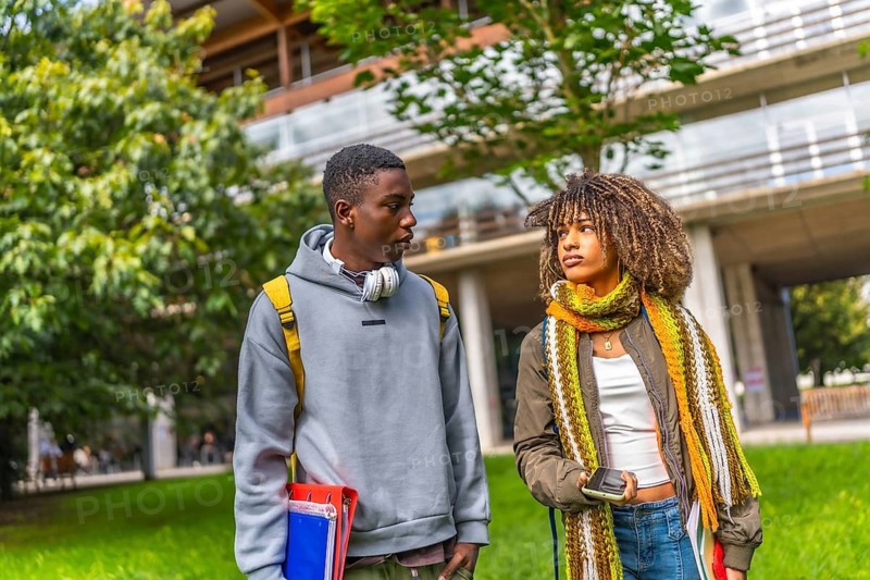 Diverse students back to university walking and talking outside the building