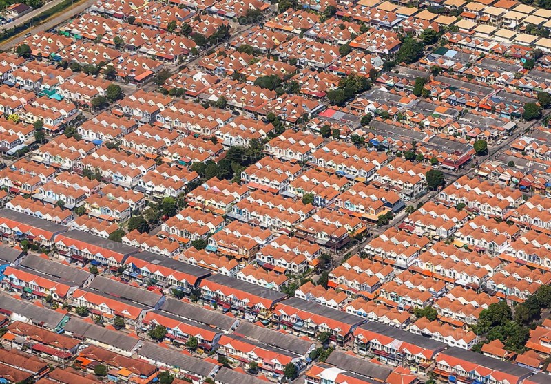 Retort city in the north-east of Bangkok. Standardised houses stand close together on the straight streets of a housing estate. Urban planning from the retort. Approaching Don Mueang Airport, Bangkok, Thailand
