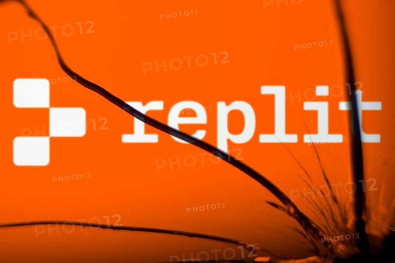 replit logo is visible on the broken glass. Replit is an American start-up and an online integrated development environment