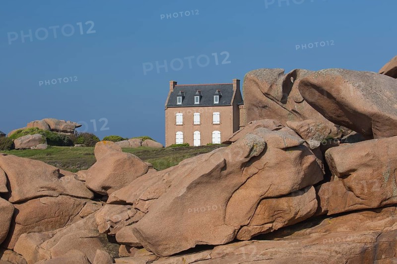 Old house next to Lighthouse Mean Ruz at Ploumanach, Cotes d'Armor in the evening light