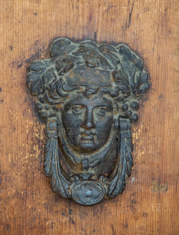 Door knocker as a human face in Urbino, Marche, Italy