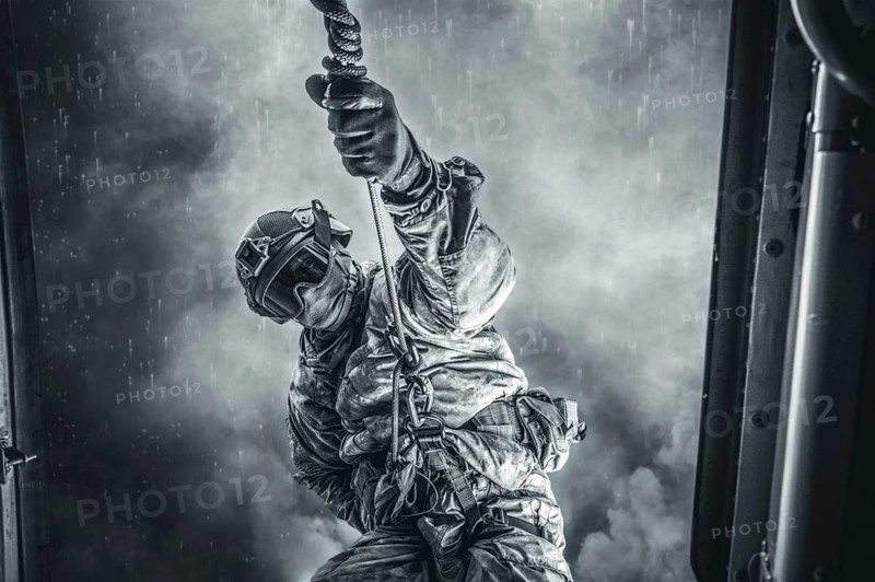 Soldier prepares to jump from a helicopter. The concept of computer games.