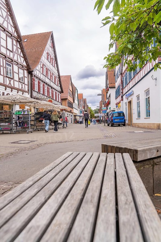 Town scene with half-timbered buildings and a busy shopping street, Kirchheim Teck, Germany