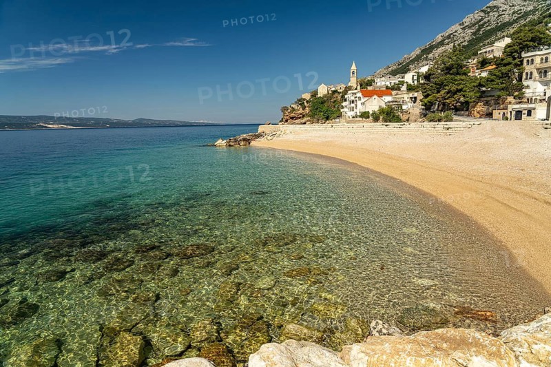 Beach and church in Pisak on the Omis Riviera, Croatia