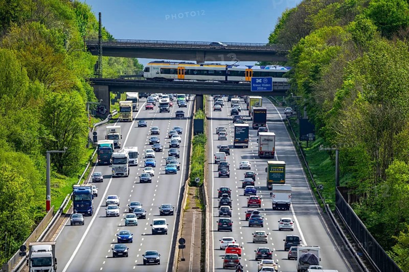 Eurobahn train, crossing the A3 motorway, traffic on 8 lanes, including the temporarily released hard shoulder, behind the Hilden motorway junction, looking south, near Erkrath, North Rhine-Westphalia, Germany