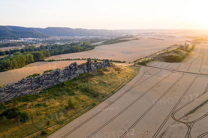 Aerial view in the last evening light of the Devil's Wall with Königsstein stone formation, in the background the town of Thale, Weddersleben, Harz, Saxony-Anhalt, Germany