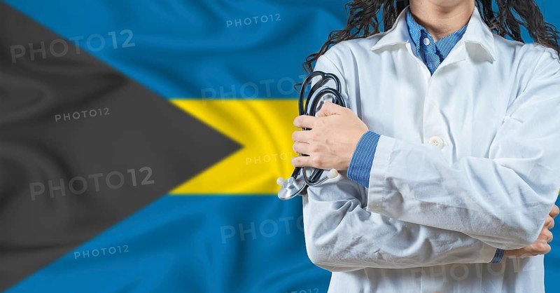 Healthcare professional with Bahamas flag background. Professional doctor holding stethoscope on Bahamas flag background
