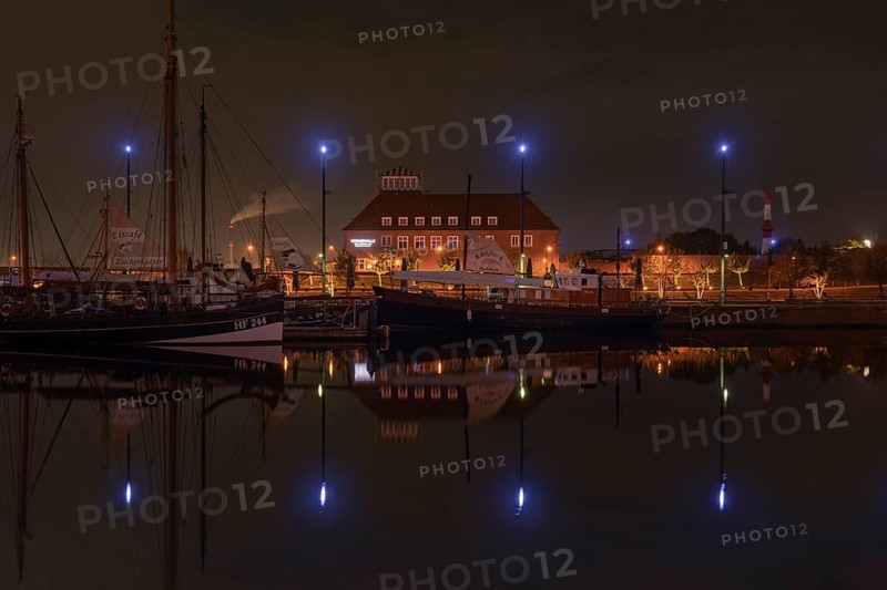 View over the new harbour to a restaurant in Bremerhaven at night, Bremerhaven, Bremen, Germany