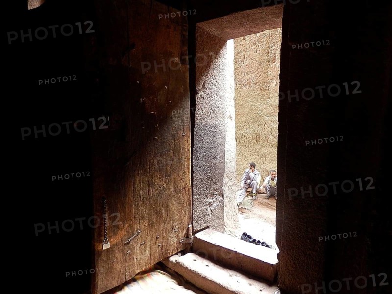 A ray of light falls through an open door into an old stone room, UNESCO World Heritage Site, Lalibela Rock Church, Ethiopia