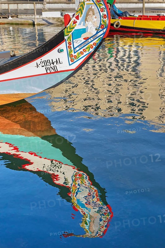 Traditional Moliceiro boat reflected in the water, Aveiro, Portugal