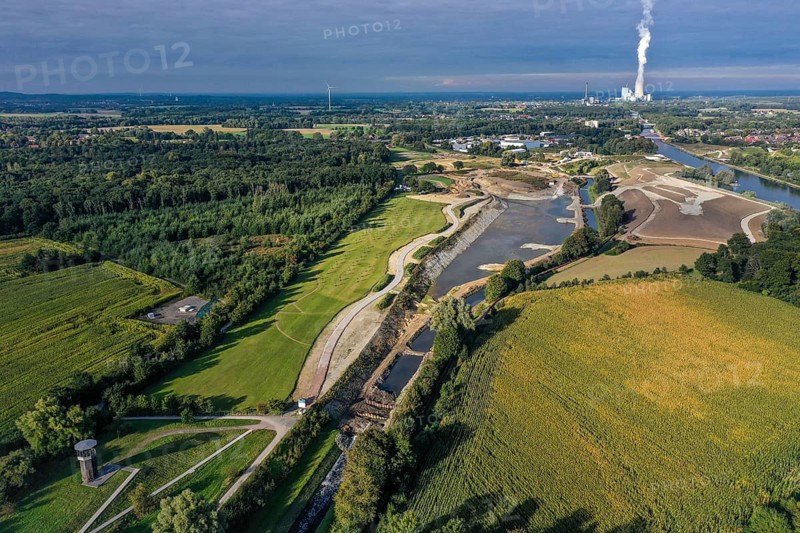 Recklinghausen, Castrop-Rauxel, North Rhine-Westphalia, Germany - EMSCHERLAND construction project, a 37-hectare water and nature discovery park at the water crossroads of the Rhine-Herne Canal (right) and the renaturalised Emscher (centre) on the city boundary of Recklinghausen and Castrop-Rauxel. The ecological focus at the confluence of Suderwicher Bach and Emscher will also be a future garden for the International Garden Exhibition 2027. Before the renaturalisation, the Emscher river system was an open, above-ground wastewater canal, combined sewer with surface water and wastewater. The Uniper power plant Datteln 4 in the background