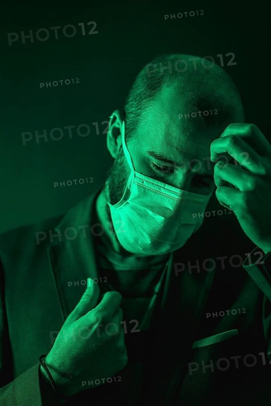 A young Caucasian man concerned about the coronavirus pandemic, Covid-19