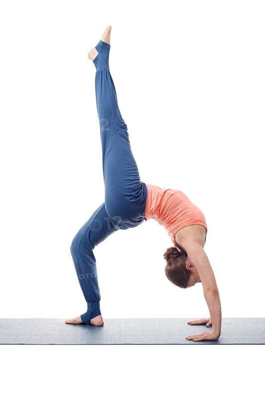 Beautiful sporty fit yogini woman practices yoga asana eka pada chakrasana (or eka pada urdva dhanurasana), one-legged wheel pose (or one-legged upward facing bow) pose isolated on white