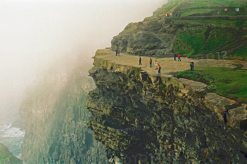 People on the edge of a cliff, there was no fence back then, Cliffs of Moher, County Clare, Republic of Ireland, April 9, 1995, vintage, retro, old, historic