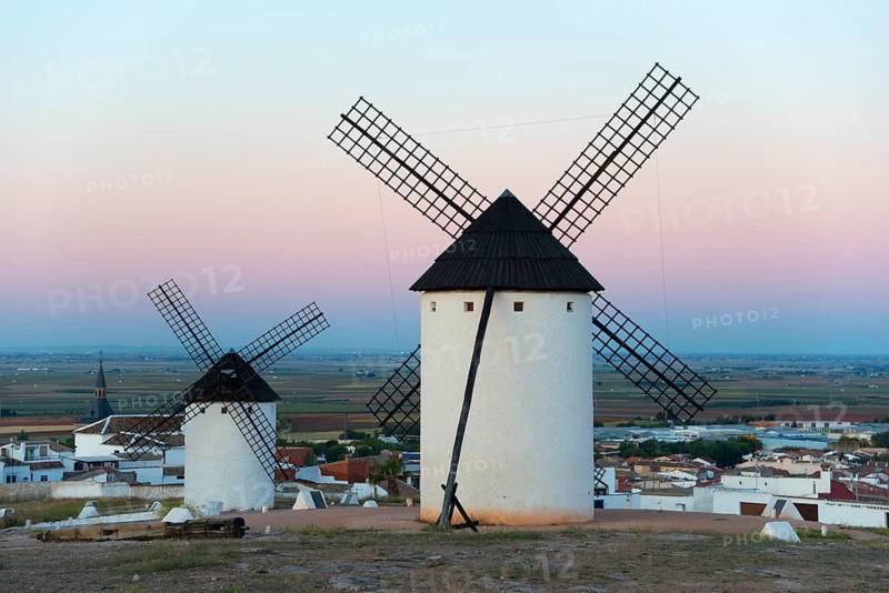 Windmills in a village at sunrise with pink sky, Campo de Criptana, Ciudad Real province, Castilla-La Mancha, Don Quixote Route, Spain