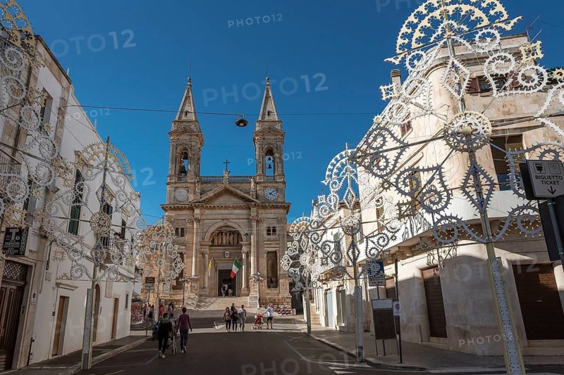 ALBEROBELLO, ITALY - SEPTEMBER 29, 2018: Basilica Santuario Dei SS. Cosma E Damiano and decoration on the street