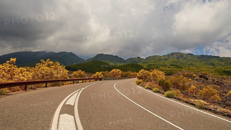 Road, curve, yellow bushes, clouds, mountains, Etna, volcano, eastern Sicily, Sicily, Italy