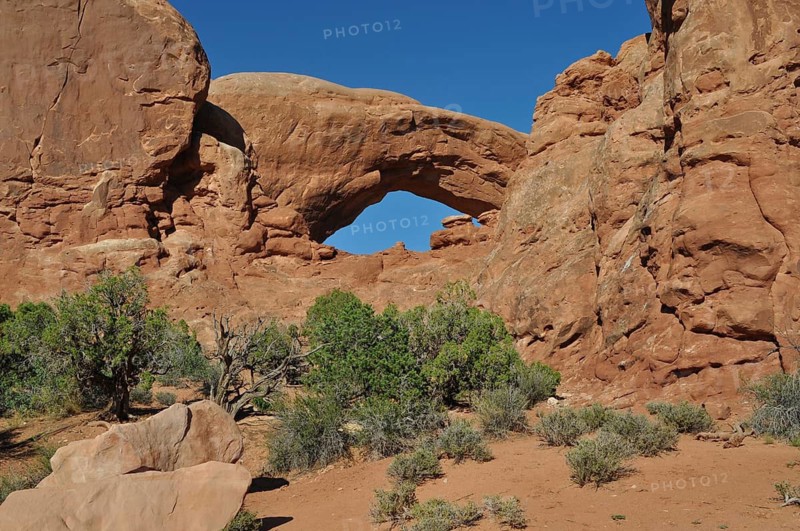 Mighty rock arch in the middle of a red rocky landscape, Arches National Park, Utah, USA