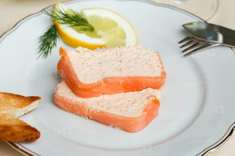 Southern German cuisine, salmon trout terrine arranged on a plate, salmon terrine with trout fillets, fish dish, salmon fillets, smoked salmon, starter, fine dining, Sunday crockery with gold rim, grandma's service, lemons, dill, fish cutlery, toast, food photography, studio, Germany