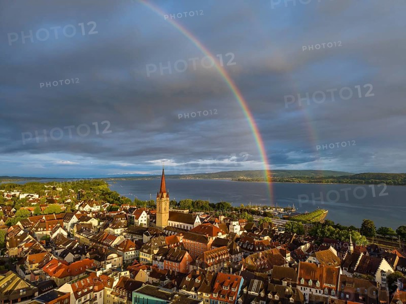Aerial view of the historic old town of Radolfzell am Lake Constance with the cathedral illuminated by the evening sun, behind it a rainbow, district of Konstanz, Baden-Württemberg, Germany