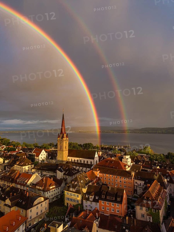 Aerial view of the historic old town of Radolfzell am Lake Constance with the cathedral illuminated by the evening sun, behind it a rainbow, district of Konstanz, Baden-Württemberg, Germany