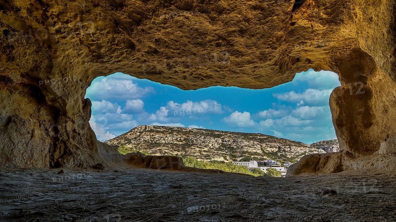 Sky changed, Neolithic caves, former hippie paradise, cave with window view of rocky landscape under blue sky, Matala, south coast, Crete, Greek islands, Greece