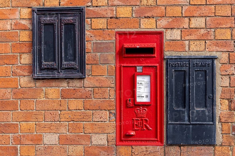 Traditional red mailbox, former stamp vending machines, house wall, Bretforton, The Cotswolds, England, Great Britain