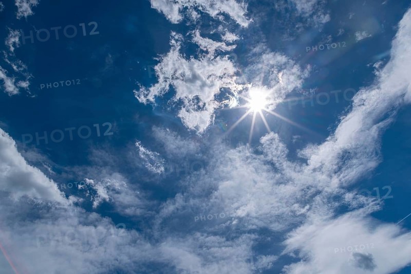 Brilliant sun above clouds in the sky, Ternitz, Lower Austria, Austria