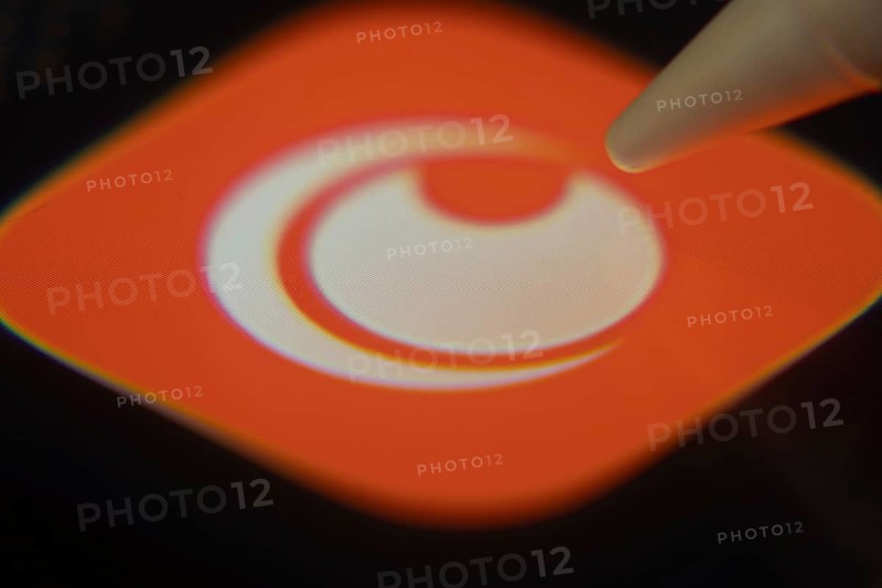 Dhaka, Bangladesh- 06 Dec 2025: Close-up of the Crunchyroll app on a screen with a stylus pointing at it