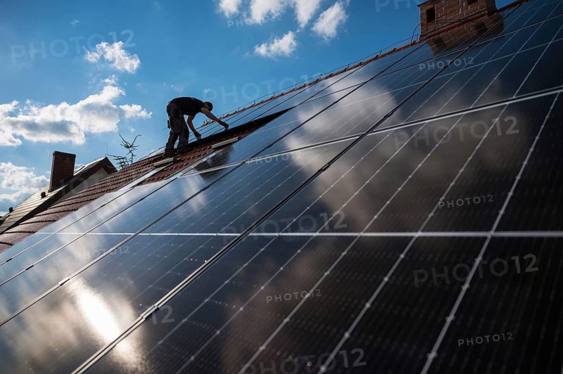 Photovoltaic panels on the roof and eingineer in the background in Tymowa, Poland