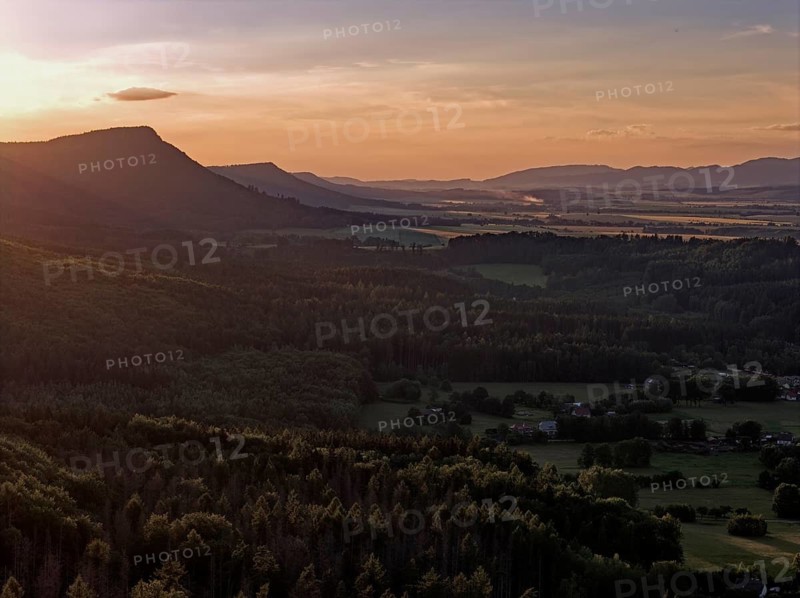 Evening atmosphere over the foothills of the Heuscheuer Mountains. The Heuscheuergebirge National Park, Park Narodowy Gopr Stolowych, is located in the Central Sudetes, Lower Silesia, in southwestern Poland. aerial view. Radkow, Szczytna, Silesia, Poland