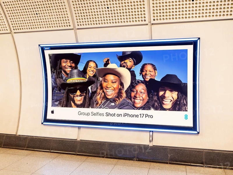 Advertising poster for Group Selfies Shot on iPhone 17 Pro, Transport for London (TfL) underground train station, London, England, UK