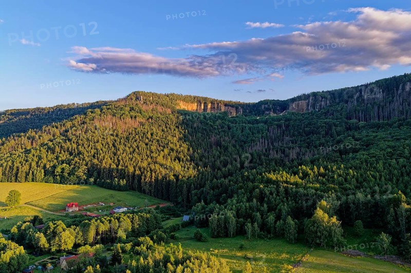 High rock formation in the evening light in the Heuscheuergebirge National Park. The Heuscheuergebirge National Park, Park Narodowy Gopr Stolowych, is located in the Central Sudetes, Lower Silesia, in southwestern Poland. aerial view. Radkow, Szczytna, Silesia, Poland