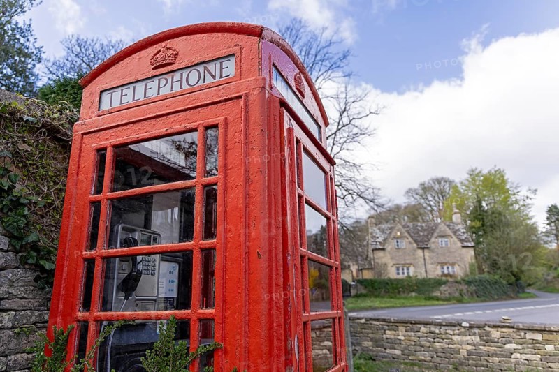 Traditional red telephone box, house, Cotswold Stone, Bibury, The Cotswolds, England, United Kingdom