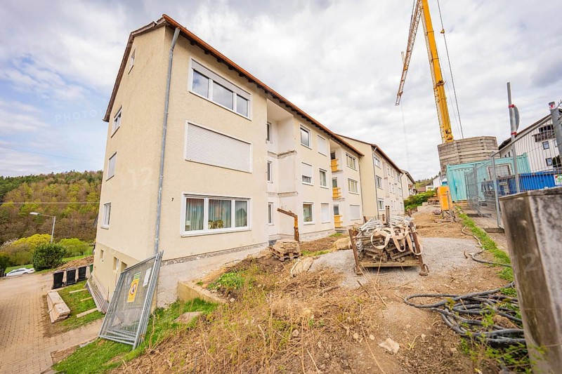 Multi-storey residential building in a suburban area with construction cranes and construction in progress, residential renovation, Nagold, Calw district, Germany
