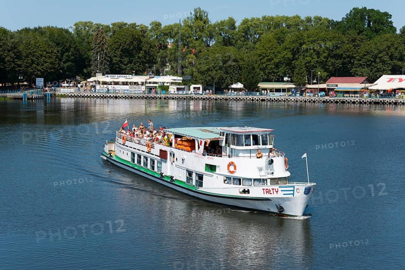 A passenger ship sails through calm waters, surrounded by green trees, ship Talty, harbour, Gizycko, Warminsko-Mazurskie, Warminsko-Mazurskie, Poland