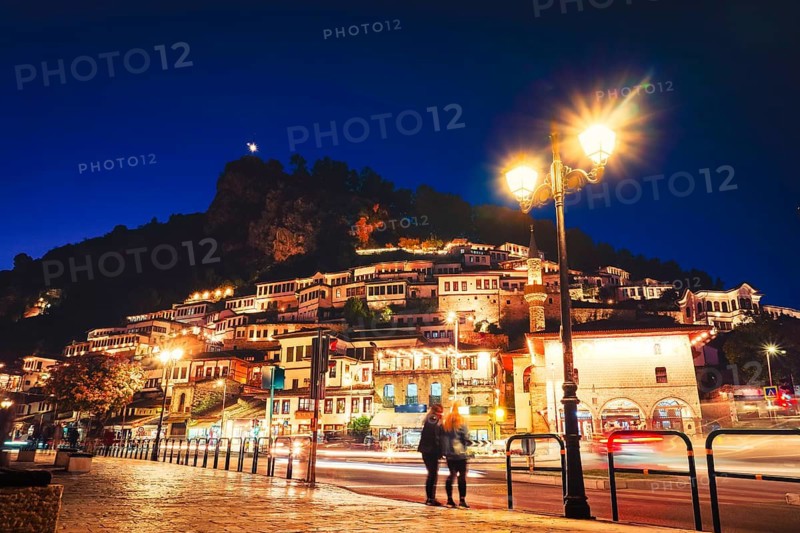 Illuminated Berat Mangalem district timelapse sunset Albania. UNESCO World Heritage site and City of a Thousand Windows. Ottoman architecture, Osum river, old town evening lights, Balkan travel