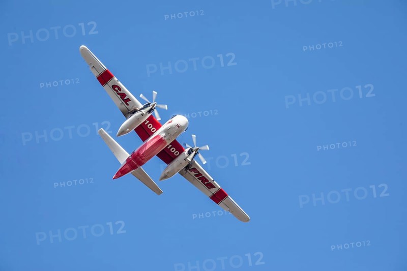 Winchester, CA USA, June 14, 2020: Cal Fire aircraft preparingto drop fire retardant on a dry hilltop wildfire near Winchester, California