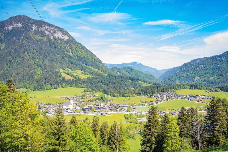 An impressive panorama of a mountain landscape with a valley, a village and forests, Bergdoktor filming locations tour, Söll, Austria
