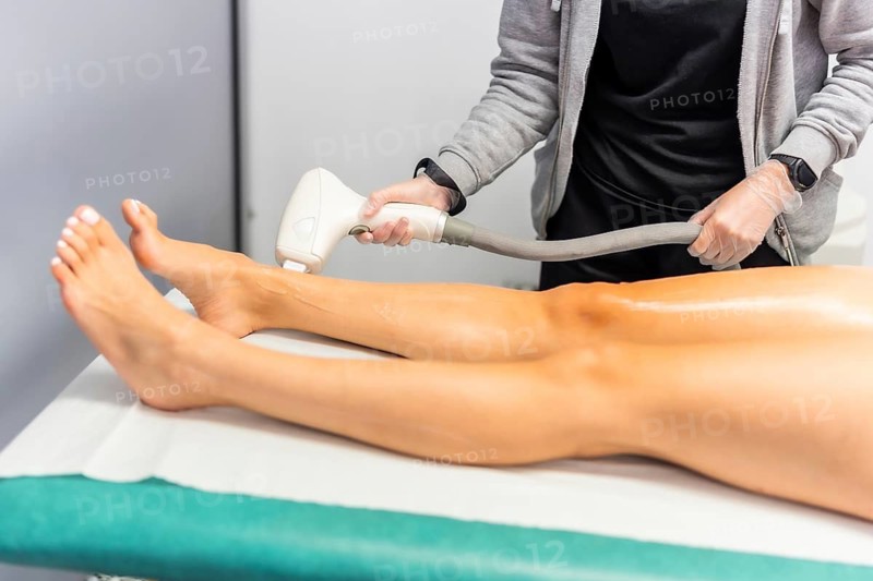 Cropped photo of the legs of a woman having a Laser hair removal treatment in a beauty salon