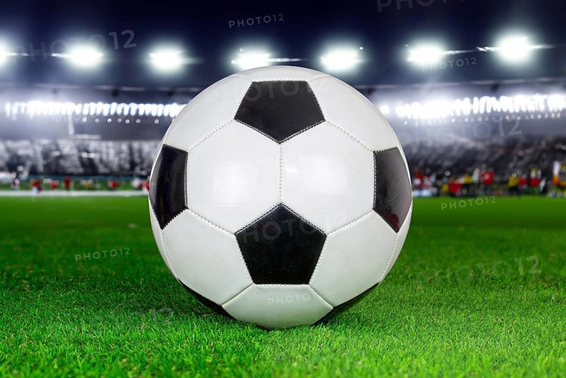 Symbolic image of football: Close-up of a black and white football in a football stadium