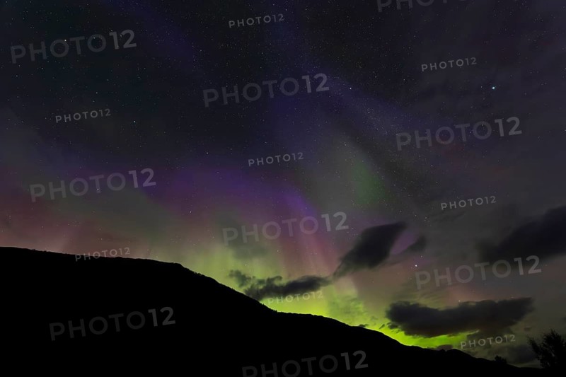 Northern lights at dawn over Sørfolda Fjord near Kjerringøy between Bodø and Sørfold in Norway