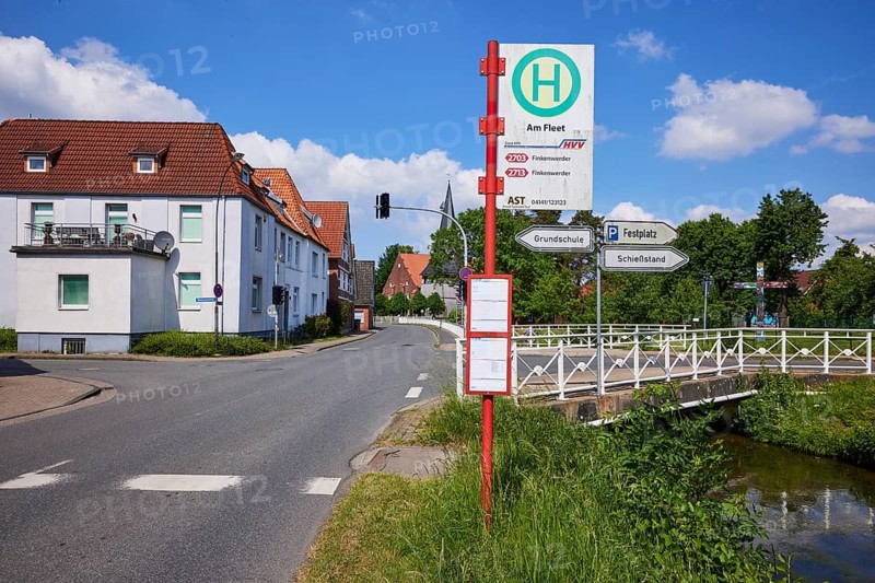 Street with bridge over the Jorker Hauptwettern and bus stop Am Fleet in Jork, Altes Land, district of Stade, Lower Saxony, Germany