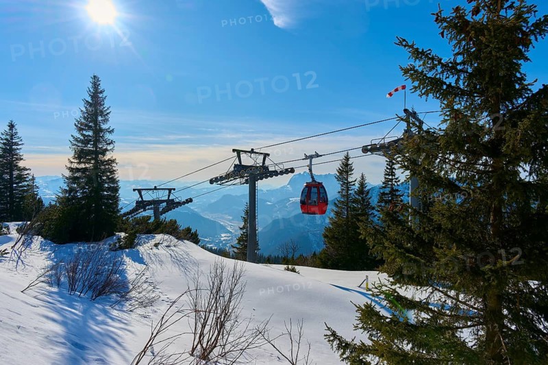 Snowy landscape with cable car and sun in the blue sky, Steinplatte, Waidring, Tyrol, Austria