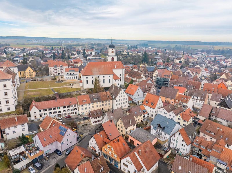Aerial view of a small town with church and red tiled roofs, surrounded by rural landscape, Meßkirch, district of Sigmaringen, Germany