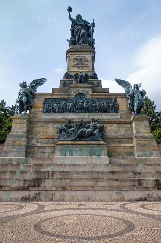 The Niederwald Monument is located on the edge of the Niederwald Landscape Park above the town of Rüdesheim am Rhein. At its feet are the vineyards of the Rüdesheimer Berg. The monument was built to commemorate the unification of Germany in 1871. Since 2002, the Niederwalddenkmal has been part of the UNESCO World Heritage Upper Middle Rhine Valley, Niederwalddenkmal, Rüdesheim am Rhein, Rhineland-Palatinate, Germany
