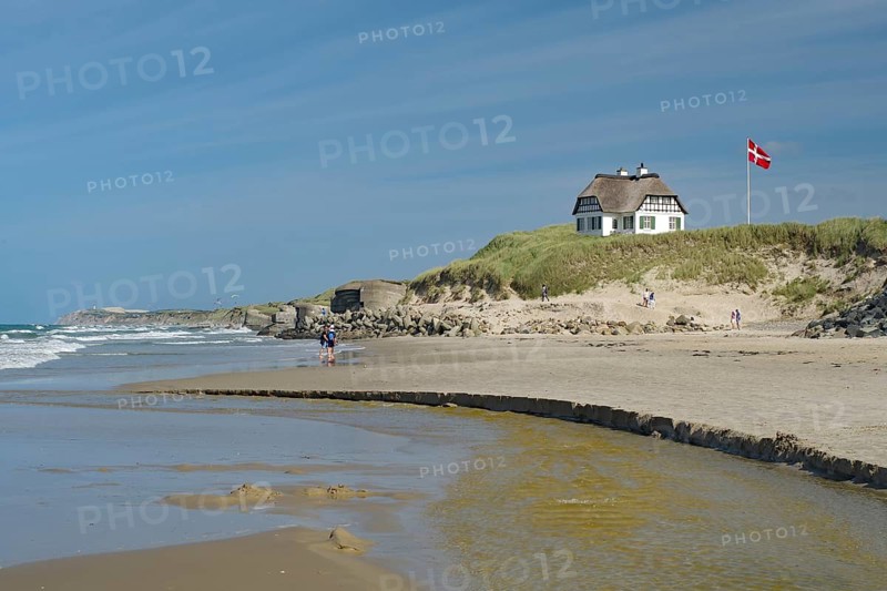 Beach landscape with a house on a hill and the Danish flag, the beach stretches along the coast, holiday, Lokken, Jutland, Denmark
