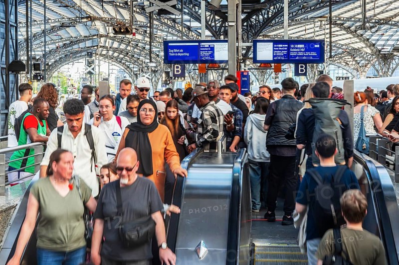 Cologne Central Station. Stairs to the platforms. Travellers waiting for their train on the platform. Crowd with motion blur. Cologne, North Rhine-Westphalia, Germany
