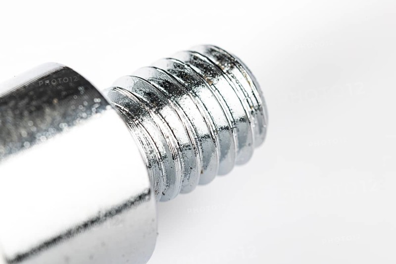 Close-up of a metal thread on a white background