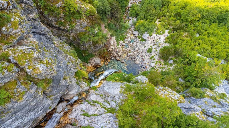 Aerial view of Grunas Waterfall in Theth National Park, Albania. Albanian Alps